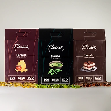 Three Elixsir syrup capsule boxes—Honey, Matcha, and Tiramisu—displayed side by side with matching colored capsules arranged in front. Each box highlights “300 capsules,” “MILD taste,” and “ECO packaging.”