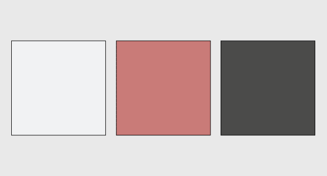 A simple color palette on a light grey background featuring three square swatches: light grey, muted terracotta pink, and dark charcoal grey.